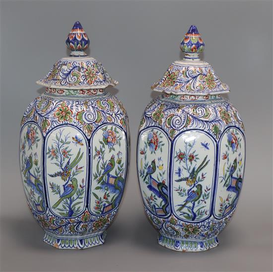 A pair of Delft polychrome lidded vases height 34cm